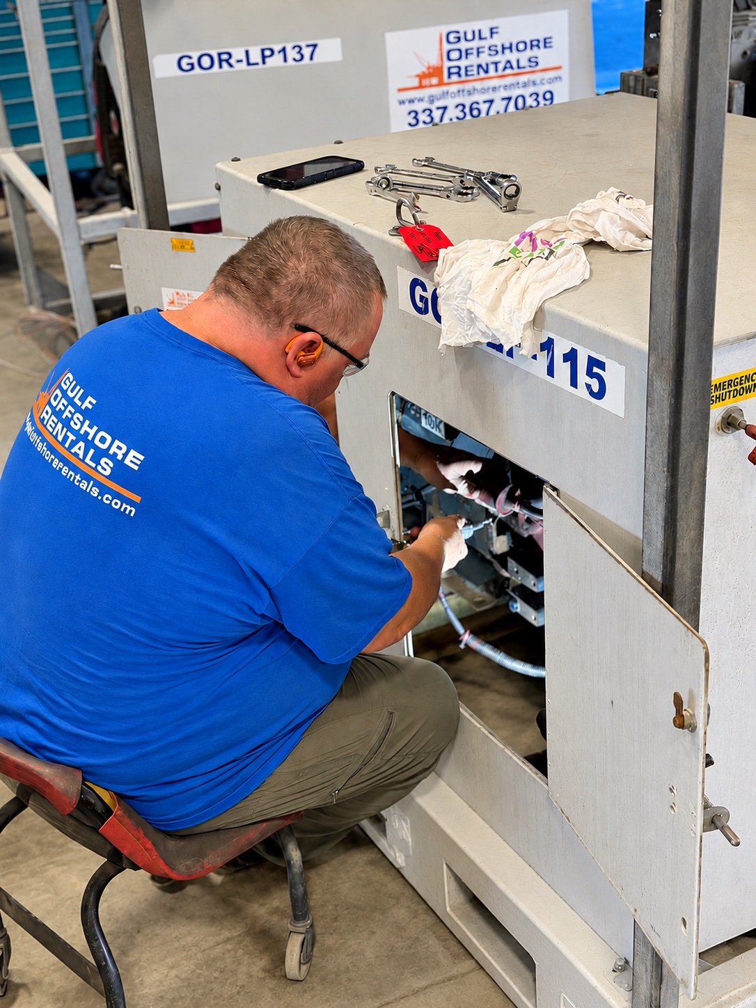 GOR technician working inside a light plant cabinet