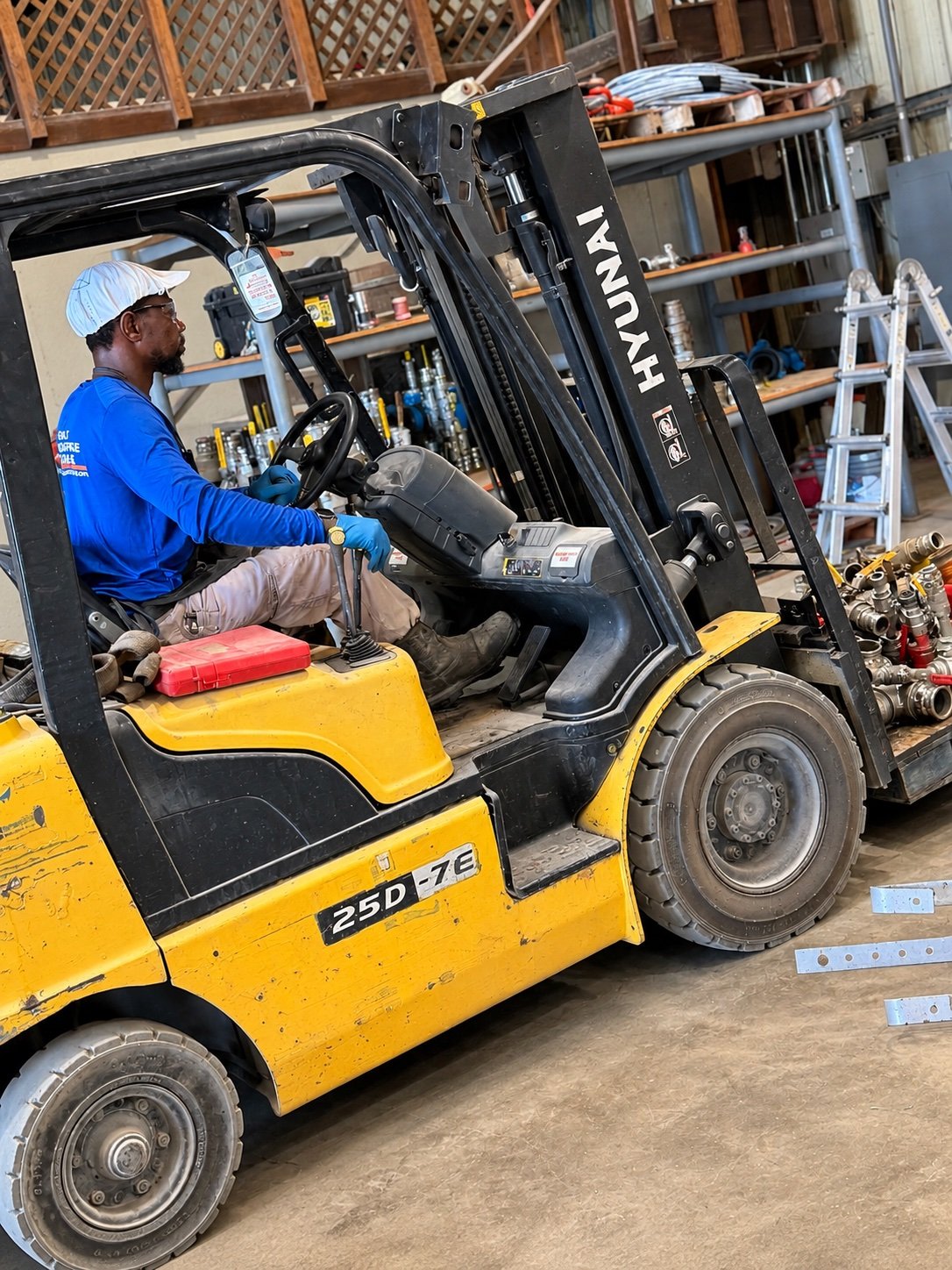 GOR operator moving equipment with a forklift in the shop